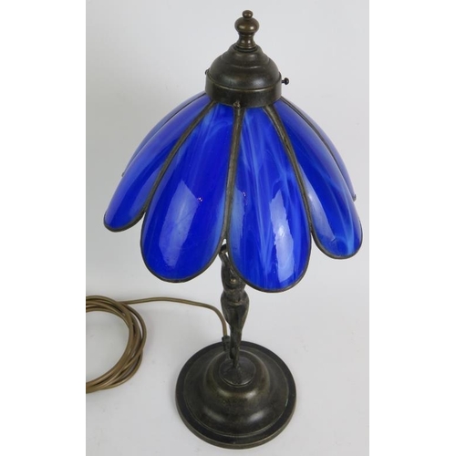 67 - A Tiffany style table lamp with bronze nude under a blue glass petal shaped shade. Overall height 47... 