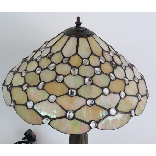 68 - A Contemporary Tiffany style table lamp on bronze lotus leaf base with a pearl stained glass shade. ... 