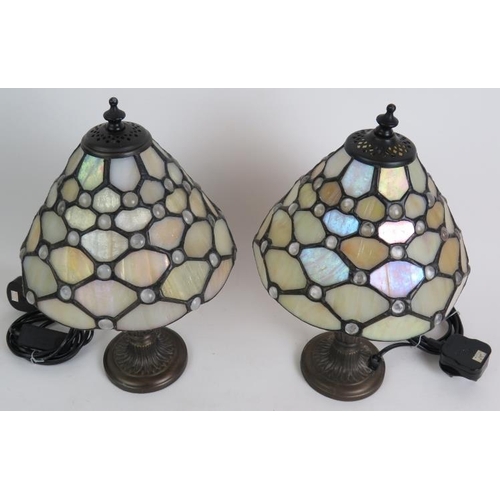 69 - A pair of Contemporary Tiffany style bedside lamps on bronze foliate bases and with pearl stained gl... 