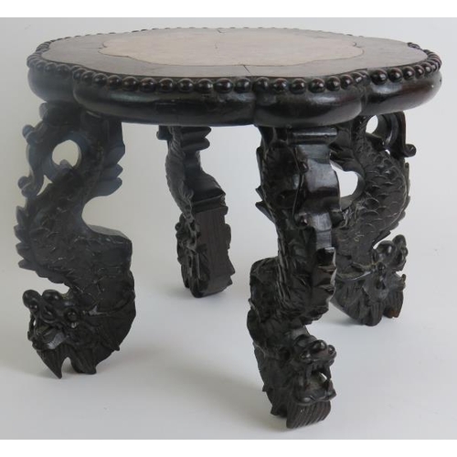 7 - An antique Chinese rosewood low pot stand with inset pink marble top within a scalloped surround wit... 