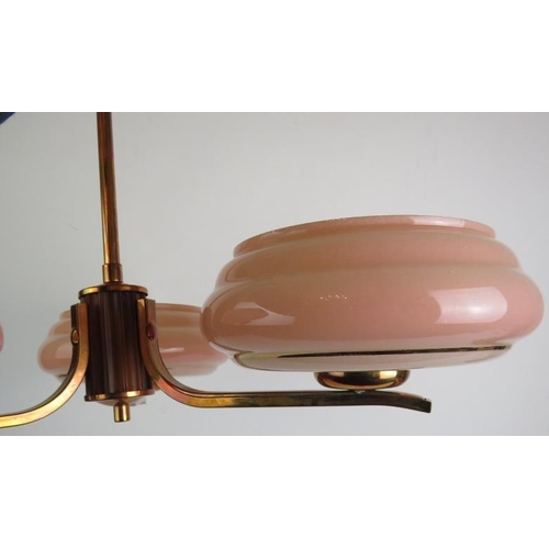 73 - A period Art Deco three branch ceiling light in polished copper with pink glass shades. Overall heig... 