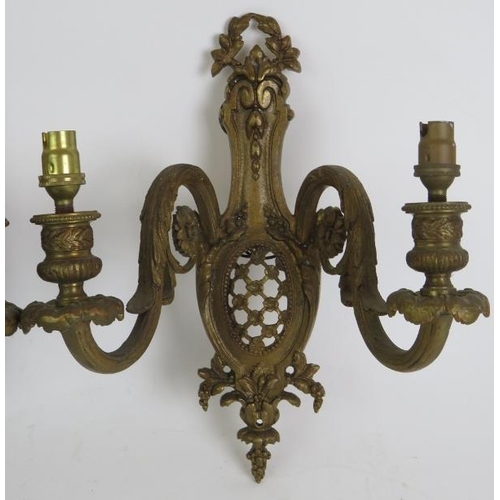 75 - A pair of heavy cast gilt brass double wall sconces in the Louis XV style. Height 29cm. Width 23cm. ... 