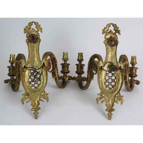 75 - A pair of heavy cast gilt brass double wall sconces in the Louis XV style. Height 29cm. Width 23cm. ... 