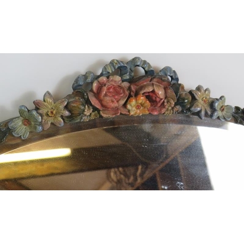 78 - An oval early 20th Century Barbola mirror with floral  moulding and bevelled glass. Width 60cm. Heig... 