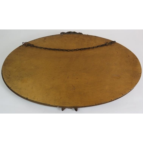 78 - An oval early 20th Century Barbola mirror with floral  moulding and bevelled glass. Width 60cm. Heig... 