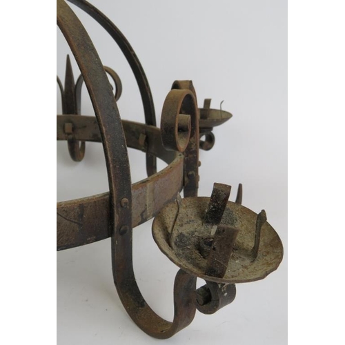 88 - A Medieval style wrought iron four sconce chandelier with heavy handing chain. Max diameter 52cm.
Co... 