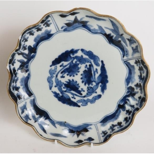 9 - A pair of antique Chinese porcelain scallop edged plates decorated in blue and white with gilded rim... 