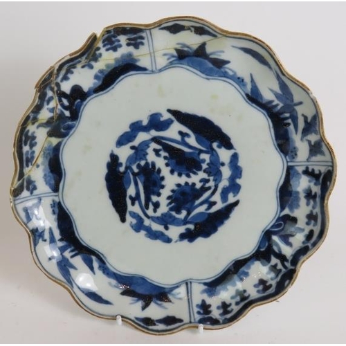 9 - A pair of antique Chinese porcelain scallop edged plates decorated in blue and white with gilded rim... 