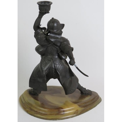 91 - A well cast metal figure of a Japanese Samurai warrior on marble style plinth. Overall height 42cm.
... 