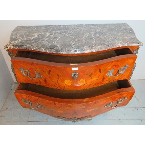 703 - A reproduction 19th century style French tulipwood commode chest featuring black serpentine marble t... 