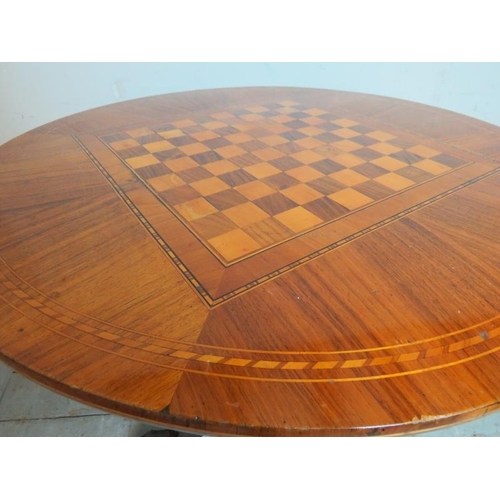 704 - A 19th century walnut parquetry inlaid circular games table, with chessboard inlay & single blind fr... 