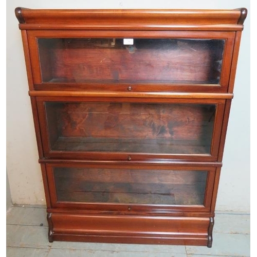 705 - A vintage mahogany three section glazed Globe Wenicke bookcase, raised on a plinth base.
Condition r... 