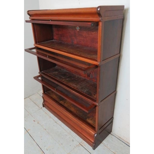 705 - A vintage mahogany three section glazed Globe Wenicke bookcase, raised on a plinth base.
Condition r... 