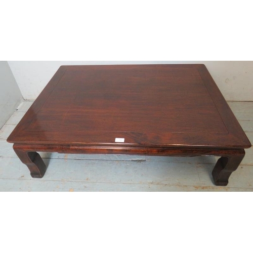 714 - An antique Chinese rosewood low rectangular coffee table, raised on shaped supports with scrolled fe... 