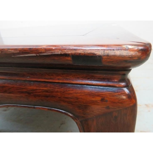 714 - An antique Chinese rosewood low rectangular coffee table, raised on shaped supports with scrolled fe... 