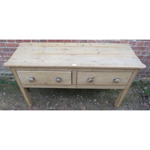 715 - An antique pine sideboard with rounded corners, housing two deep drawers with turned wooden knob han... 