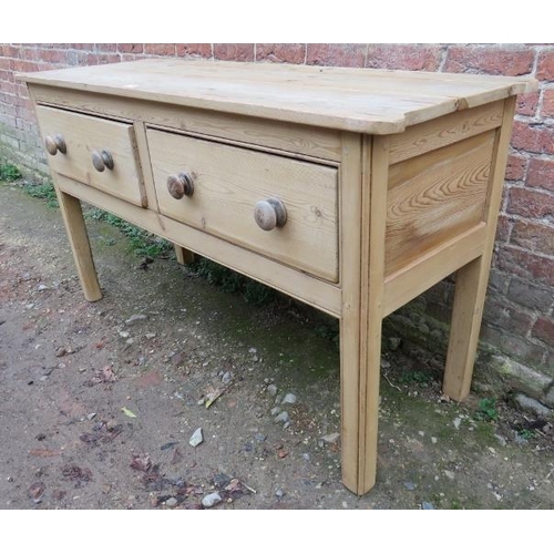 715 - An antique pine sideboard with rounded corners, housing two deep drawers with turned wooden knob han... 