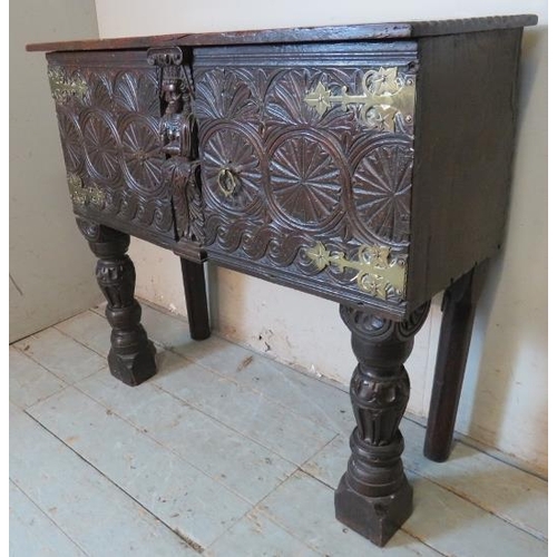 716 - An antique oak sideboard, composed of ornately carved 17th century elements, with two cupboard doors... 