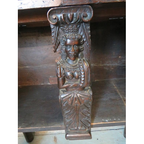 716 - An antique oak sideboard, composed of ornately carved 17th century elements, with two cupboard doors... 