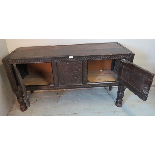 717 - A large antique oak sideboard composed of ornately carved 17th century elements, featuring carved fr... 