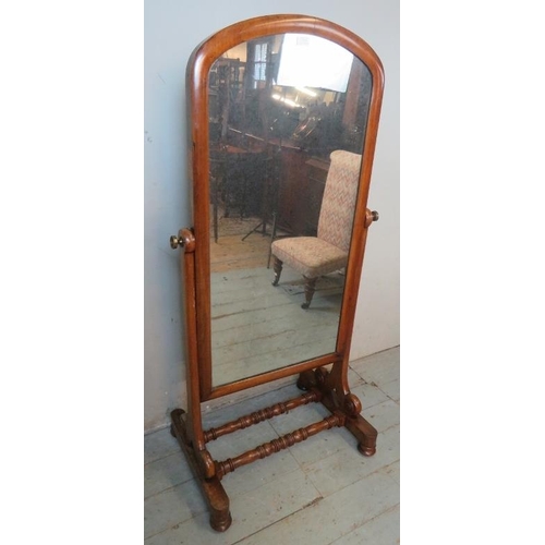 723 - A 19th century mahogany framed gentleman's cheval mirror raised on scrolled side supports over a bas... 