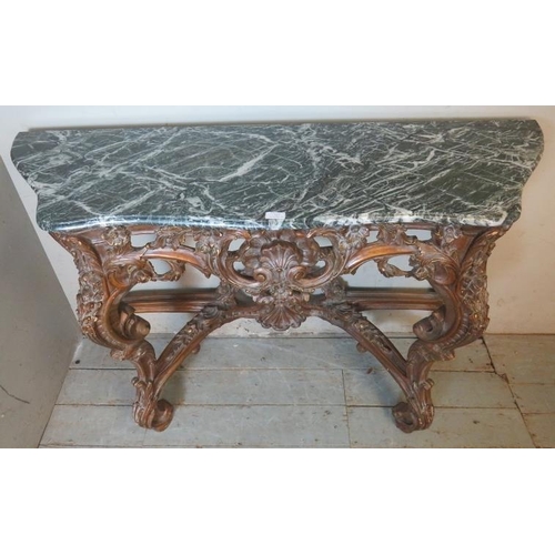 727 - A very ornate serpentine front console table in the Renaissance taste with black Italian marble top,... 