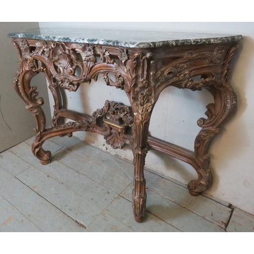 727 - A very ornate serpentine front console table in the Renaissance taste with black Italian marble top,... 