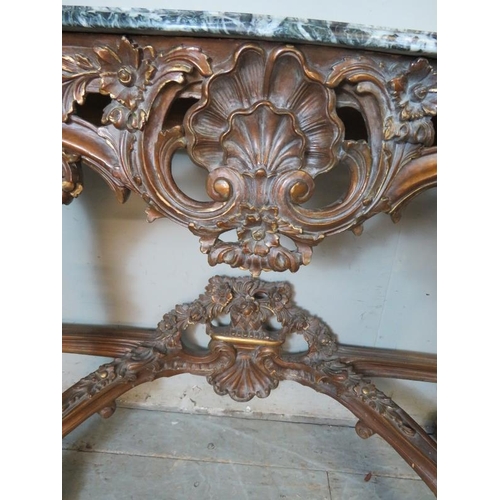 727 - A very ornate serpentine front console table in the Renaissance taste with black Italian marble top,... 