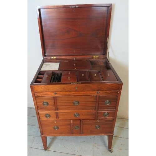 729 - A George III mahogany gentleman's enclosed dressing table, the hinged top enclosing a fitted interio... 