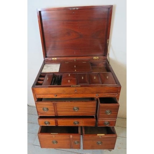 729 - A George III mahogany gentleman's enclosed dressing table, the hinged top enclosing a fitted interio... 