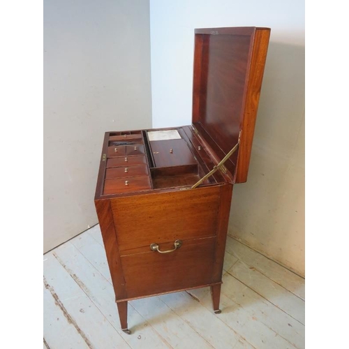 729 - A George III mahogany gentleman's enclosed dressing table, the hinged top enclosing a fitted interio... 