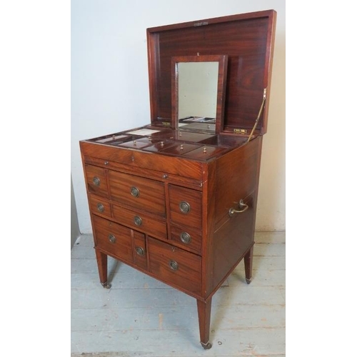 729 - A George III mahogany gentleman's enclosed dressing table, the hinged top enclosing a fitted interio... 