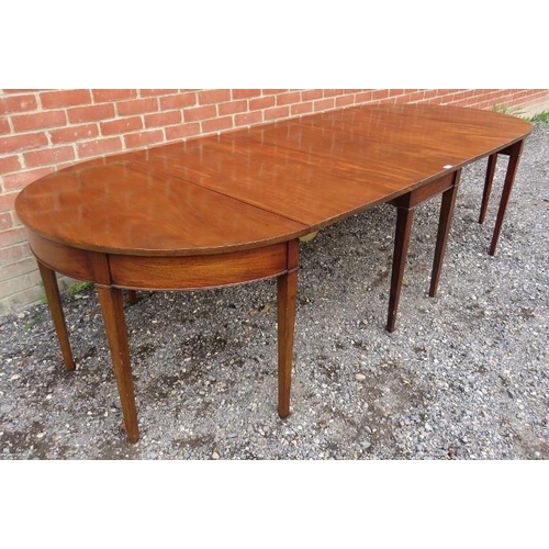 736 - A Georgian mahogany drop leaf dining table with two removable 'D end' sections, raised on tapering s... 