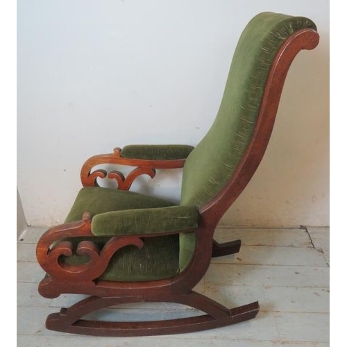 739 - A Victorian mahogany rocking chair with scrolled backrest & scrolled pierced armrests, upholstered i... 