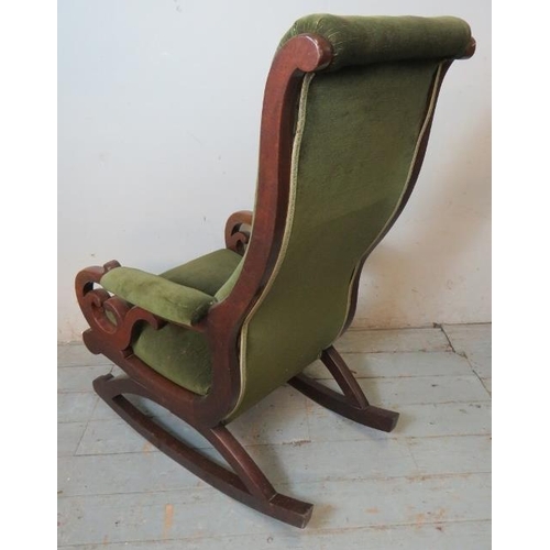 739 - A Victorian mahogany rocking chair with scrolled backrest & scrolled pierced armrests, upholstered i... 