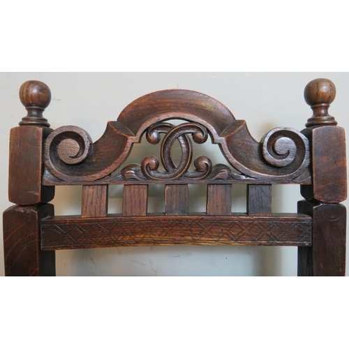 748 - A turn of the century oak music seat in the Jacobean revival taste, with scrolled & pierced backrest... 