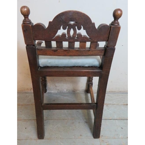 748 - A turn of the century oak music seat in the Jacobean revival taste, with scrolled & pierced backrest... 