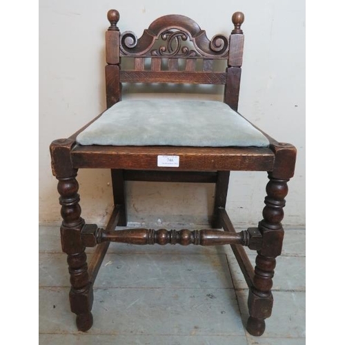 748 - A turn of the century oak music seat in the Jacobean revival taste, with scrolled & pierced backrest... 