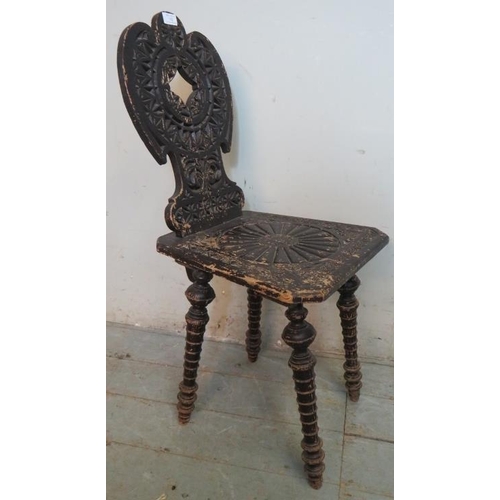 762 - A turn of the century aesthetic period oak hall chair, the shaped & pierced back rests and seat heav... 