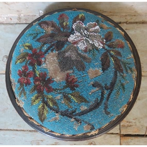 770 - A 19th century ebonised & gilt-metal mounted small circular footstool with beaded floral decoration,... 