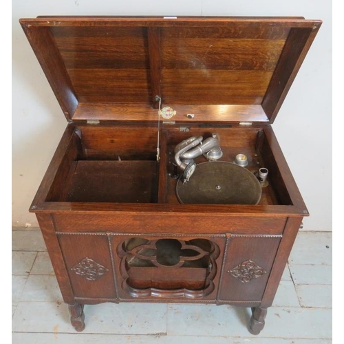 789 - A 1920's oak cased freestanding gramophone by Gilbert with applied moulded decoration to case and ta... 