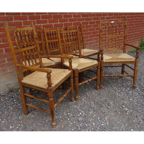 793 - A set of six (4 + 2) antique style medium oak spindle back Lancashire kitchen chairs with rush seats... 