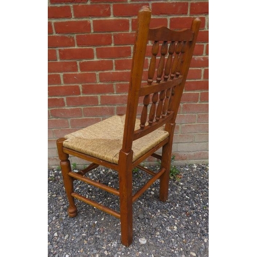 793 - A set of six (4 + 2) antique style medium oak spindle back Lancashire kitchen chairs with rush seats... 