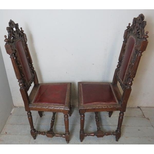 794 - A pair of vintage oak hall chairs ornately carved in the Carolean taste with acanthus leaves & scrol... 