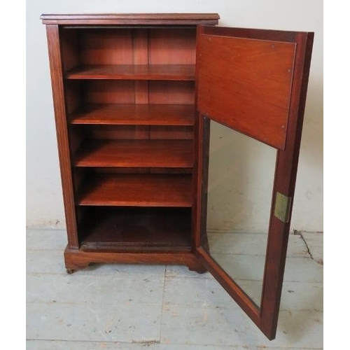 800 - An Edwardian rosewood marquetry inlaid music cabinet, the glazed door inset with two rectangular bev... 