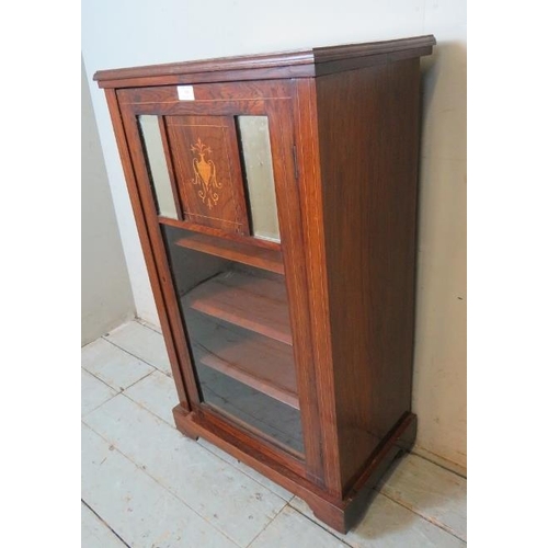 800 - An Edwardian rosewood marquetry inlaid music cabinet, the glazed door inset with two rectangular bev... 