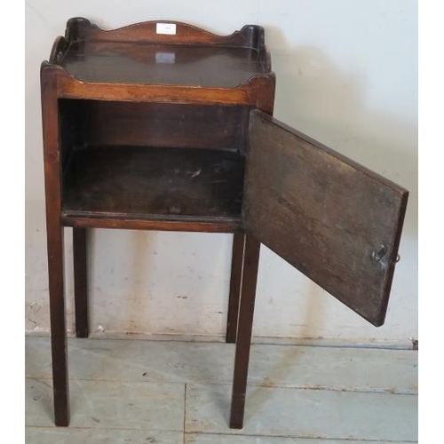 804 - A George III mahogany bedside cabinet with shaped gallery, raised on chamfered square supports.
Cond... 