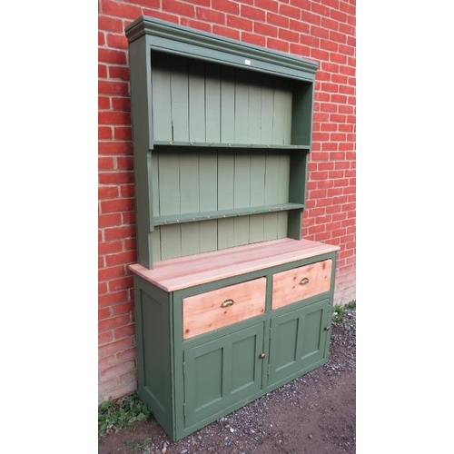 808 - An antique pine kitchen dresser painted green with plate rack shelving over a sideboard base contain... 