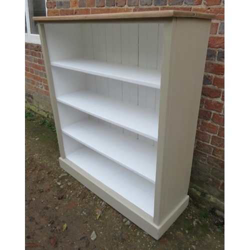 810 - A low open bookcase containing three fitted shelves painted light green with light oak top, raised o... 