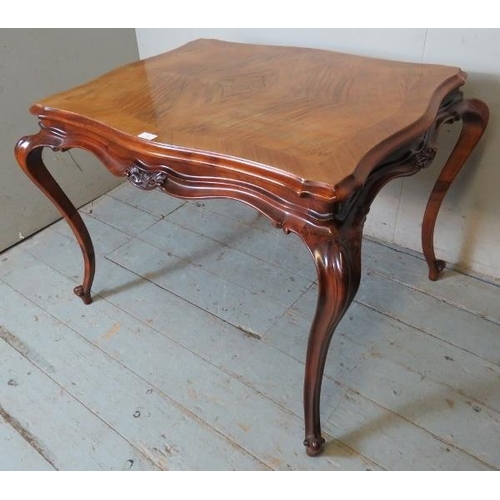 822 - A 19th century style French walnut centre table with quarter veneer serpentine edged top & shaped fr... 